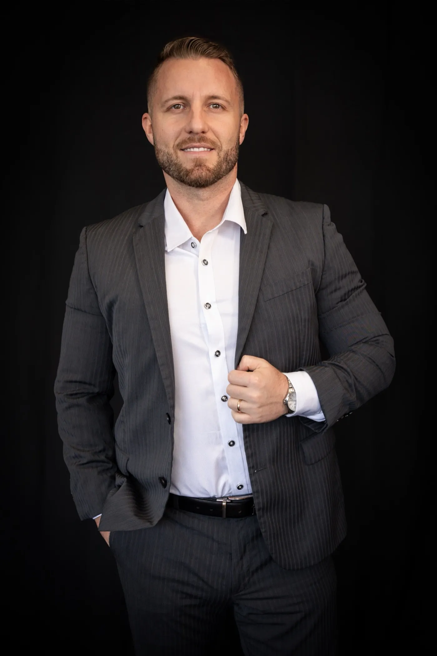 Mikael Khaldi, MK Alliance Group team lead, photographed against a black studio backdrop